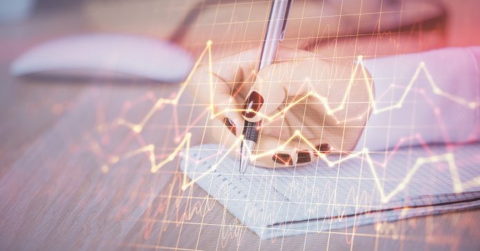 Multi exposure of hands making notes with forex chart huds. Stock market concept.